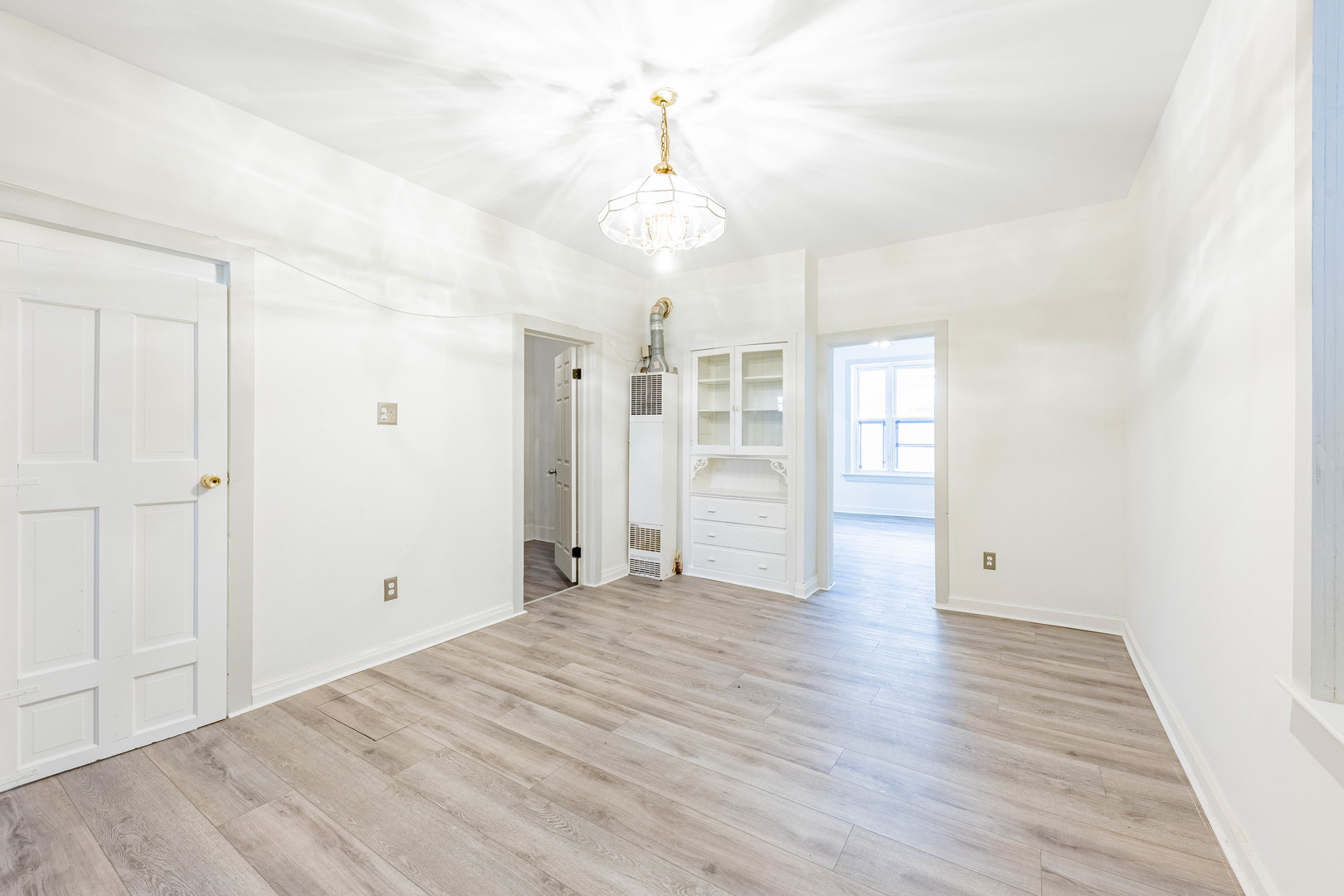 3022 South Homan Avenue Chicago, IL 60623 - Photo 3 of 29 a view of empty room with wooden floor and fan