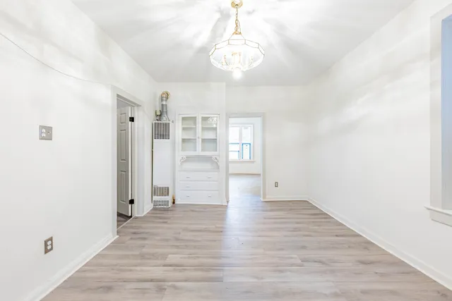 a view of a room with wooden floor and window