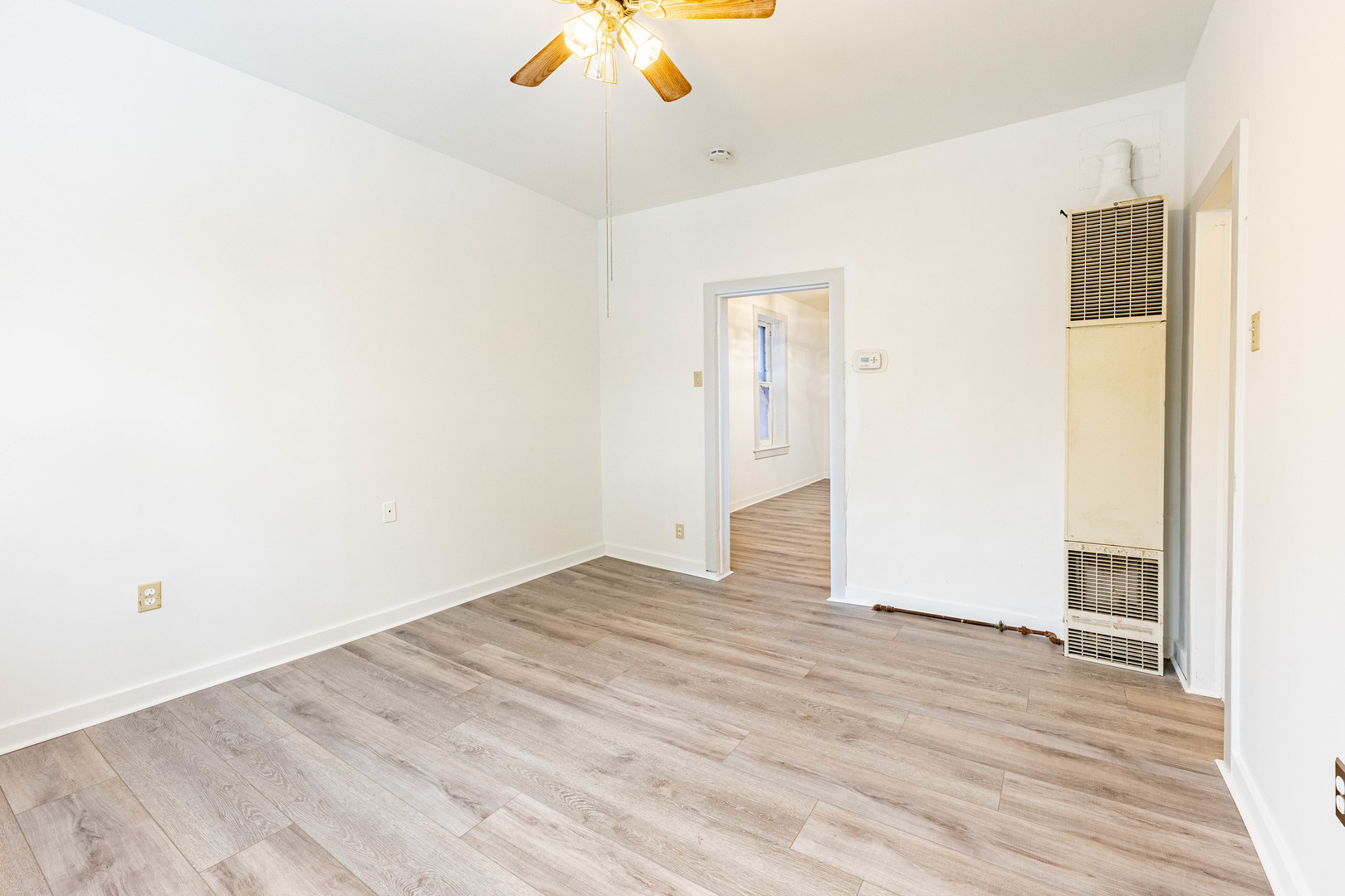 3022 South Homan Avenue Chicago, IL 60623 - Photo 7 of 29 a view of an empty room with wooden floor
