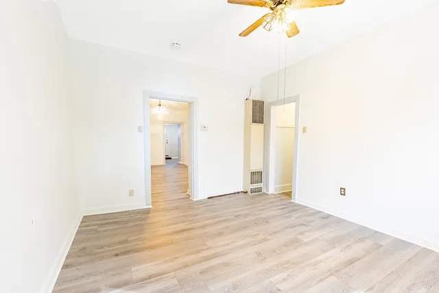 a view of a room with wooden floor