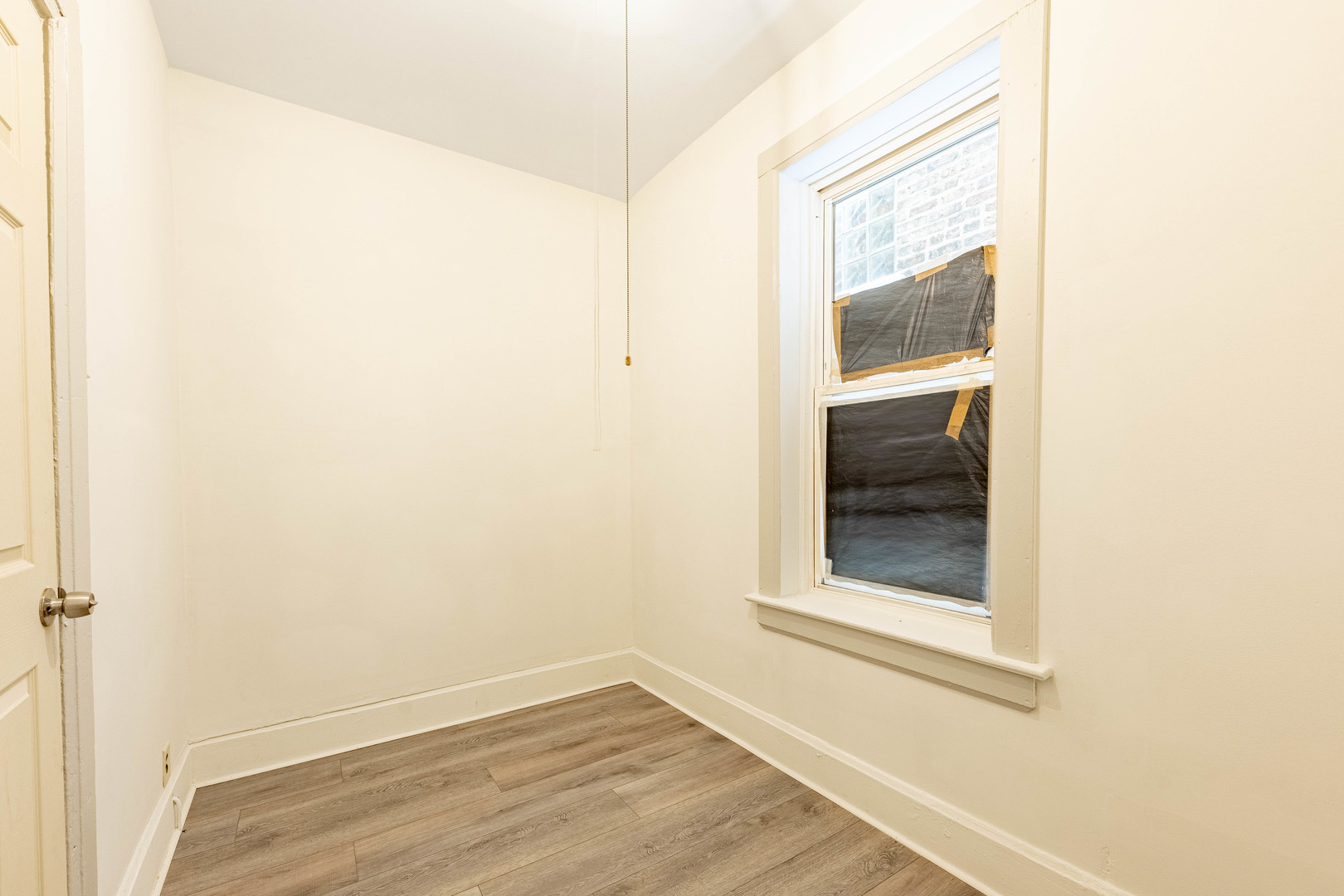 3022 South Homan Avenue Chicago, IL 60623 - Photo 10 of 29 a view of a small space with wooden floor and a window
