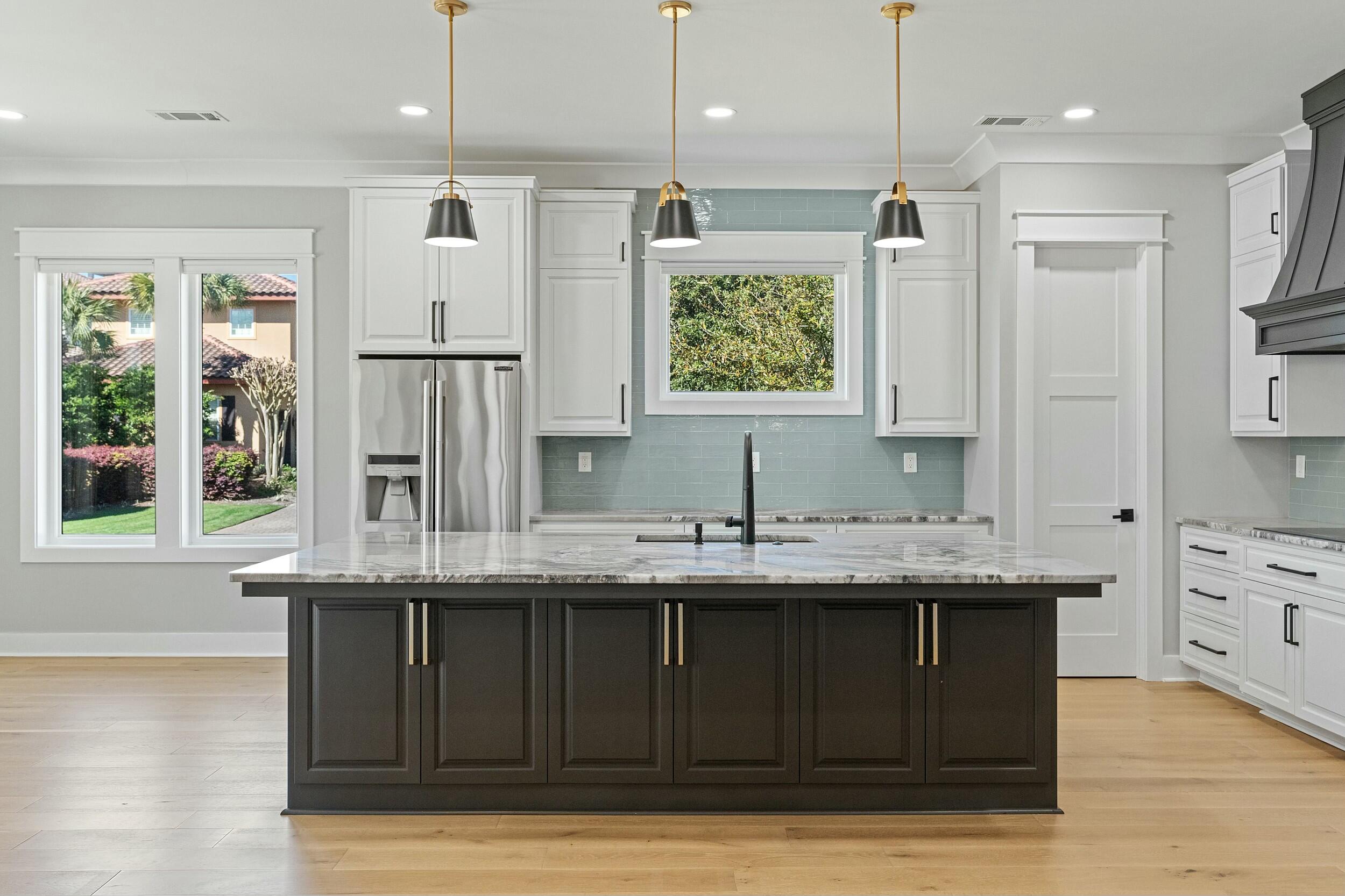 198 Emerald Ridge Santa Rosa Beach, FL 32459 - Photo 14 of 66 a kitchen with stainless steel appliances granite countertop a sink a large window and wooden floor