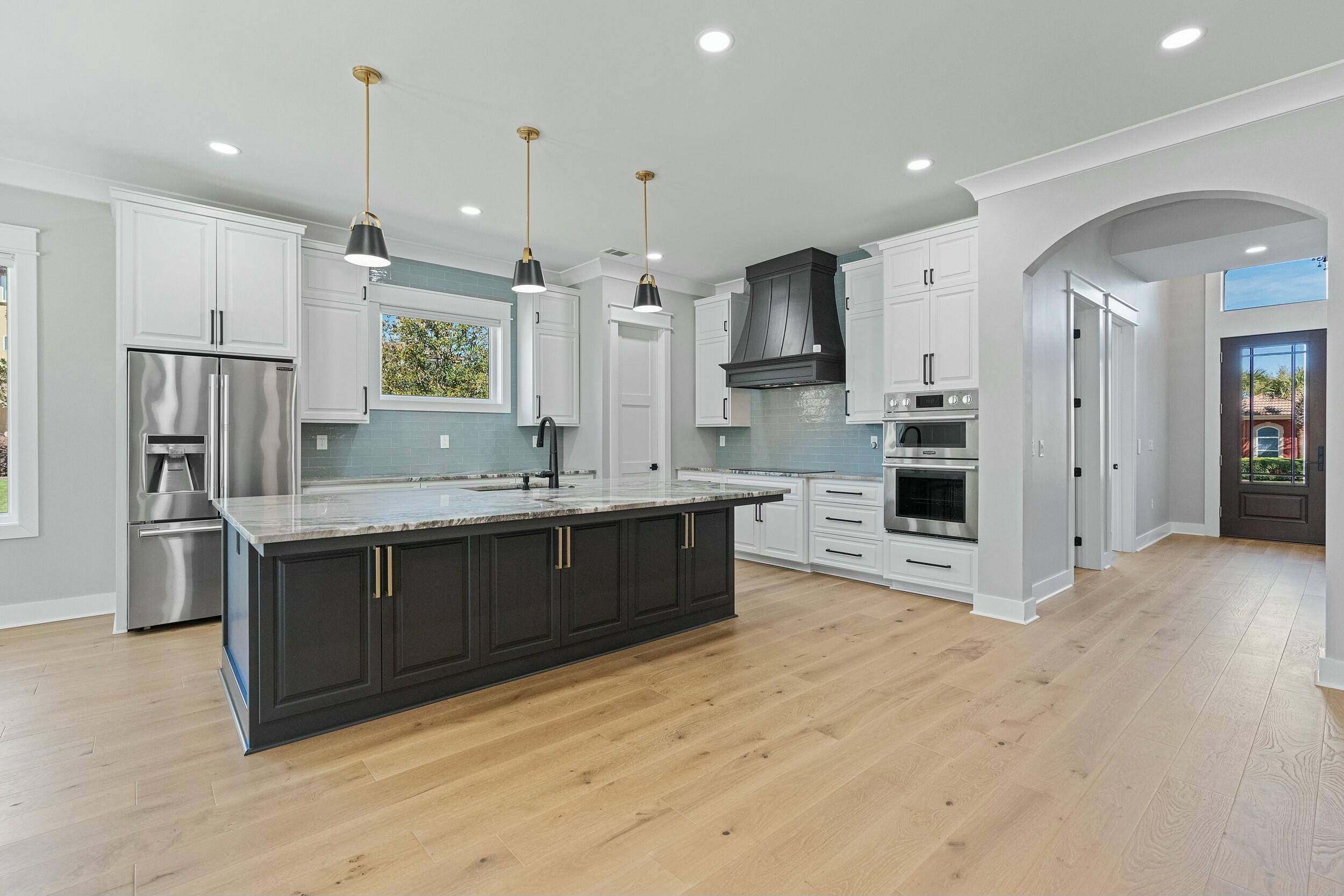 198 Emerald Ridge Santa Rosa Beach, FL 32459 - Photo 15 of 66 a large kitchen with stainless steel appliances kitchen island granite countertop a refrigerator and a sink