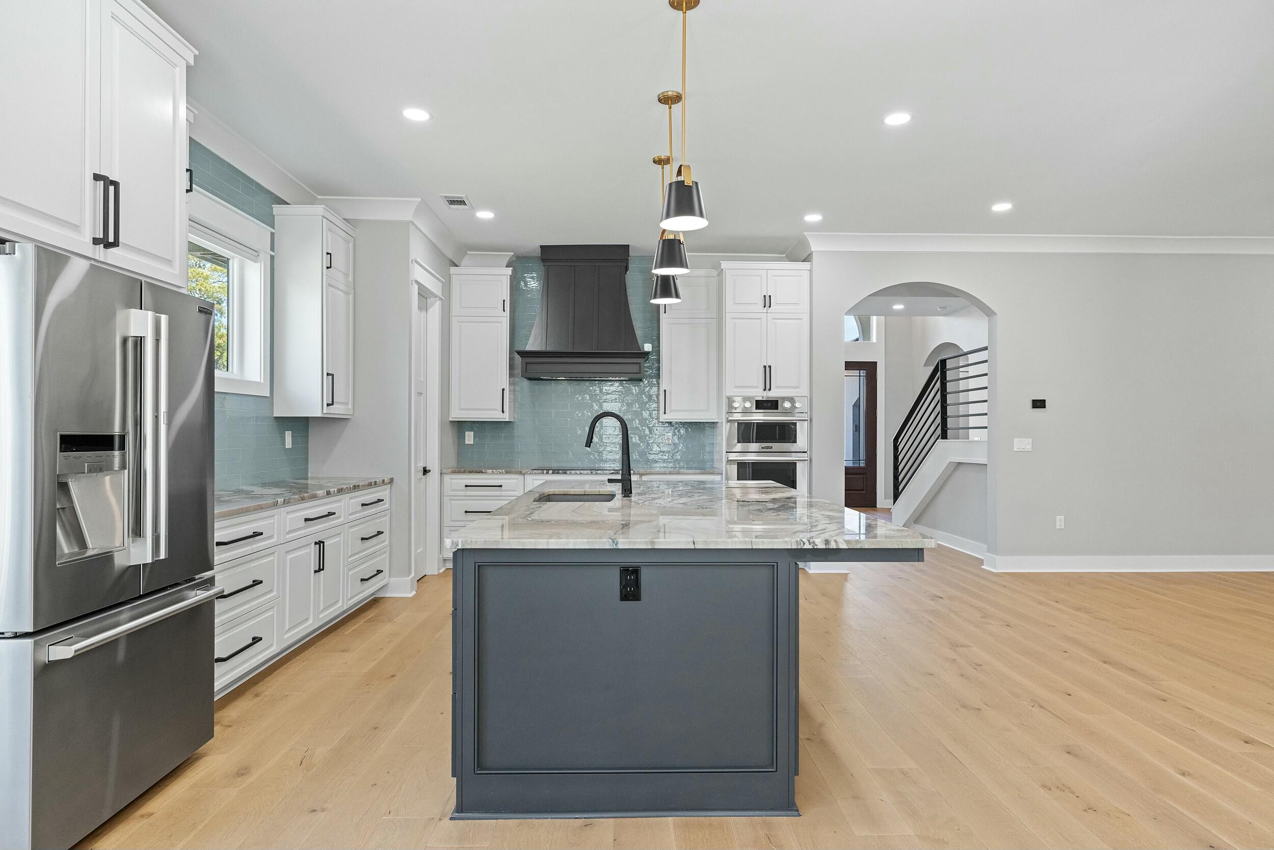 198 Emerald Ridge Santa Rosa Beach, FL 32459 - Photo 16 of 66 a kitchen with kitchen island a sink stainless steel appliances and cabinets