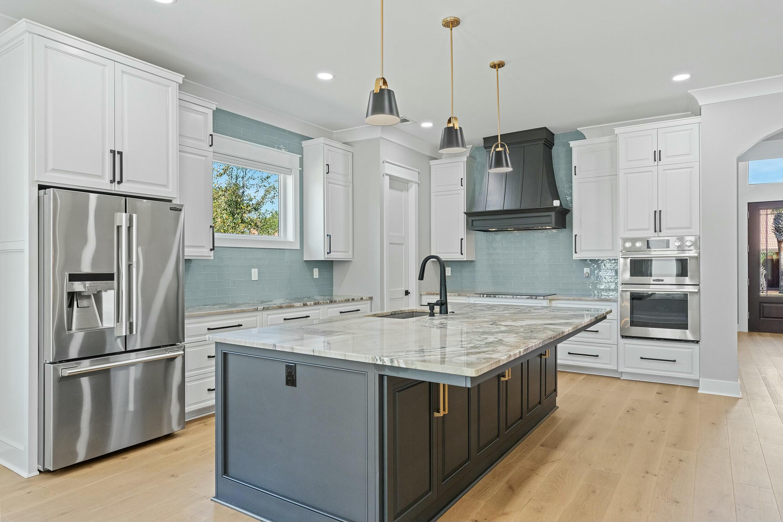 198 Emerald Ridge Santa Rosa Beach, FL 32459 - Photo 17 of 66 a kitchen with stainless steel appliances granite countertop a sink stove and refrigerator