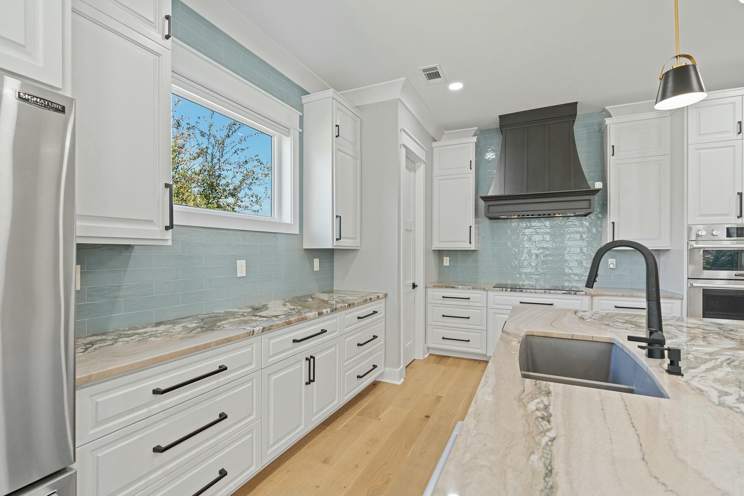 198 Emerald Ridge Santa Rosa Beach, FL 32459 - Photo 18 of 66 a kitchen with stainless steel appliances a sink stove and cabinets
