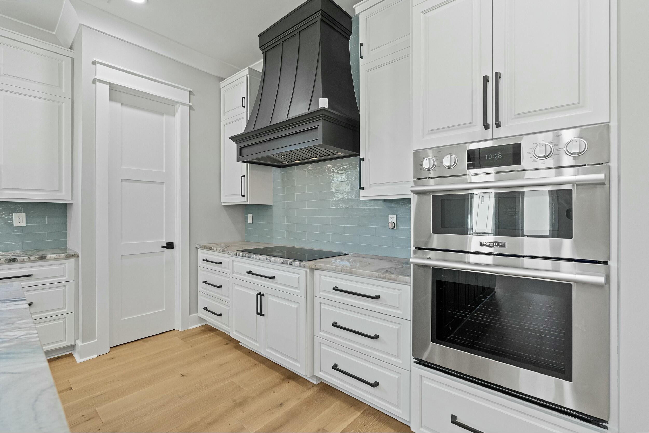 198 Emerald Ridge Santa Rosa Beach, FL 32459 - Photo 20 of 66 a kitchen with stainless steel appliances granite countertop a stove and a microwave