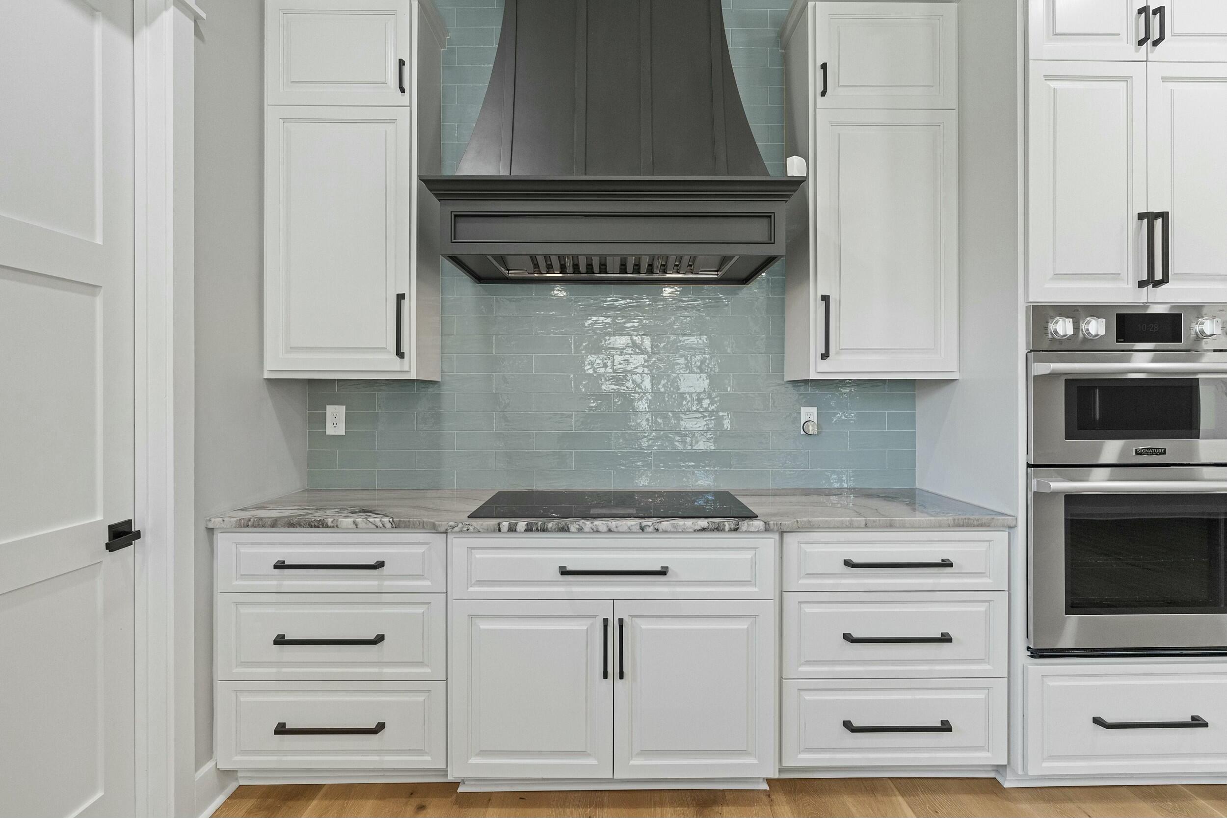 198 Emerald Ridge Santa Rosa Beach, FL 32459 - Photo 21 of 66 a kitchen with white cabinets and appliances