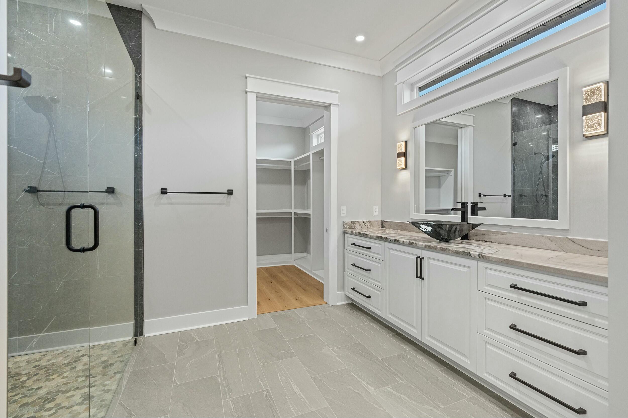 198 Emerald Ridge Santa Rosa Beach, FL 32459 - Photo 34 of 66 a spacious bathroom with a shower sink and mirror