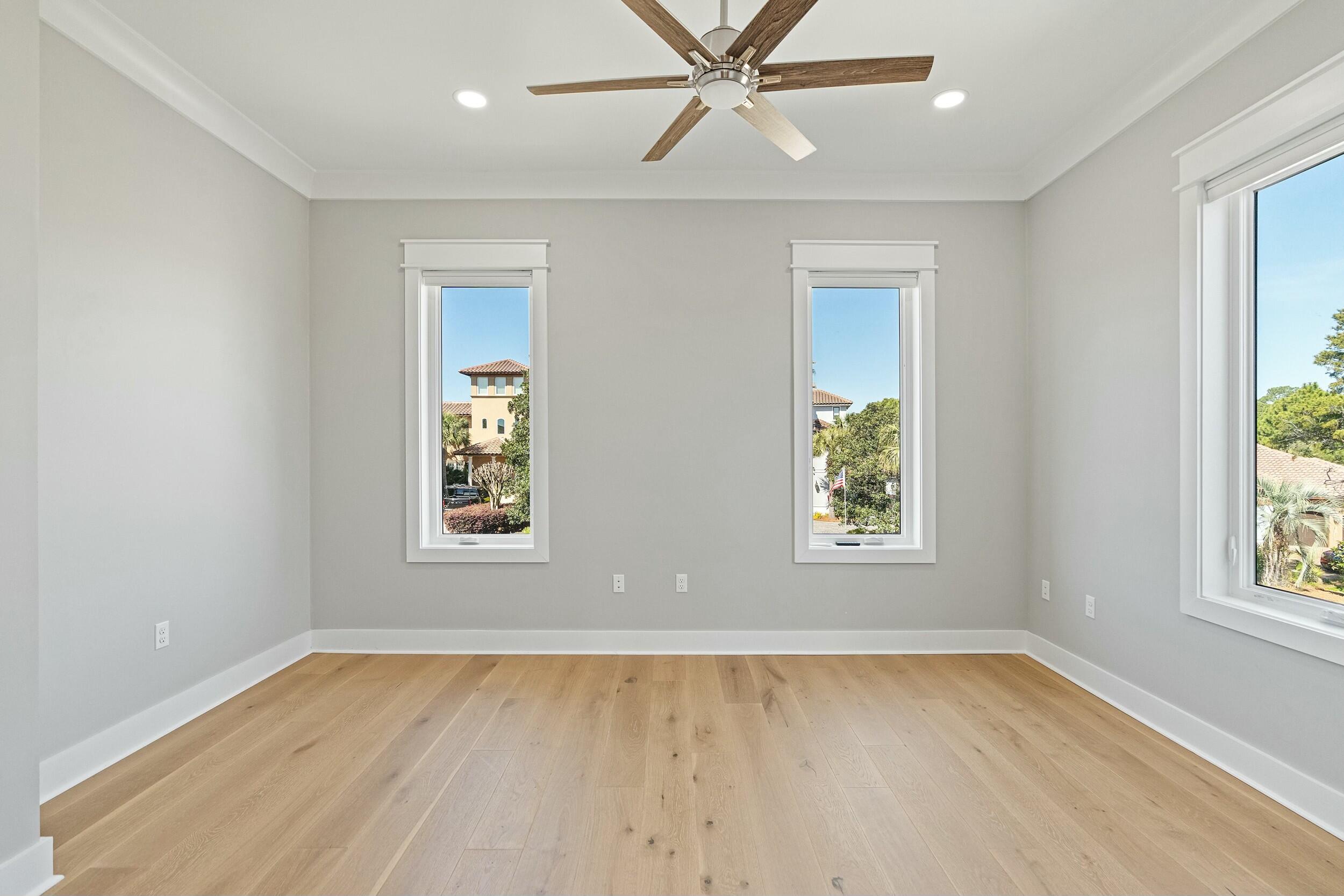 198 Emerald Ridge Santa Rosa Beach, FL 32459 - Photo 46 of 66 an empty room with a window and wooden floor
