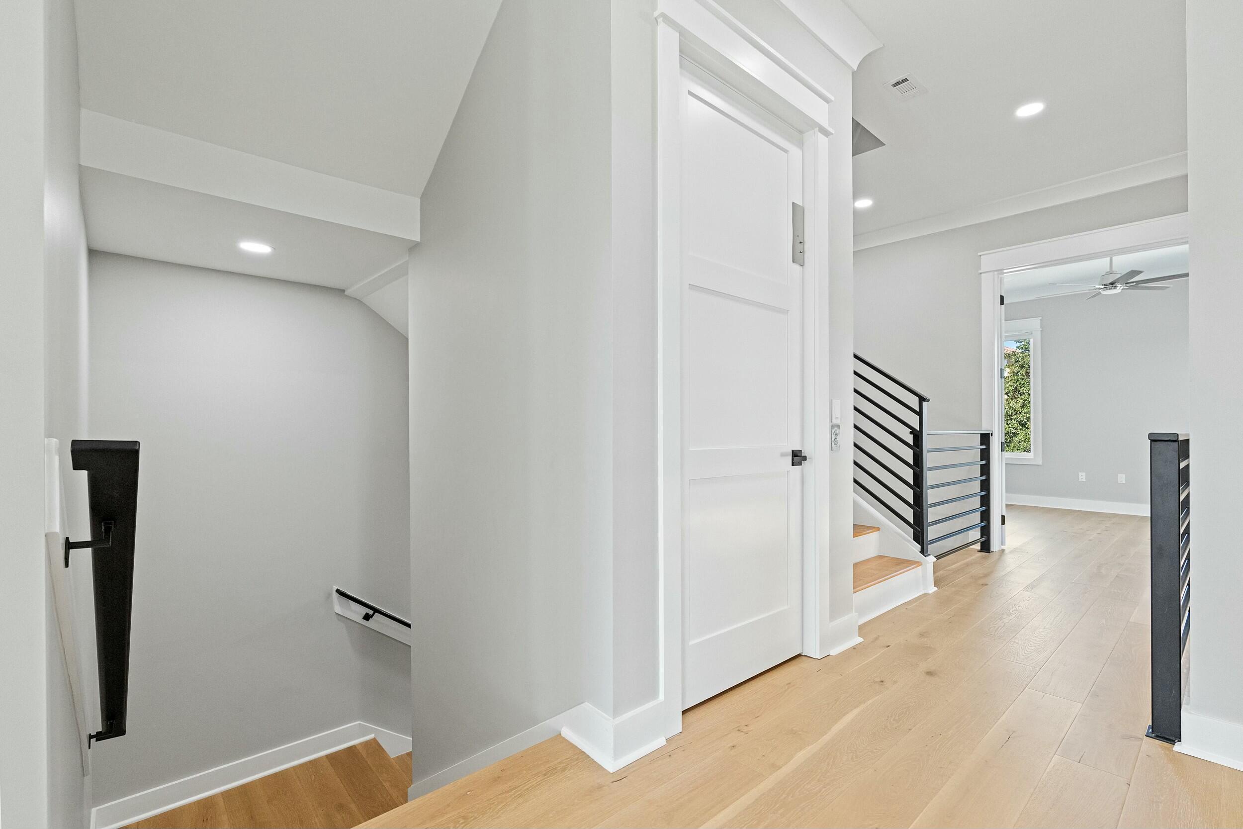 198 Emerald Ridge Santa Rosa Beach, FL 32459 - Photo 47 of 66 a view of a hallway with wooden floor and staircase