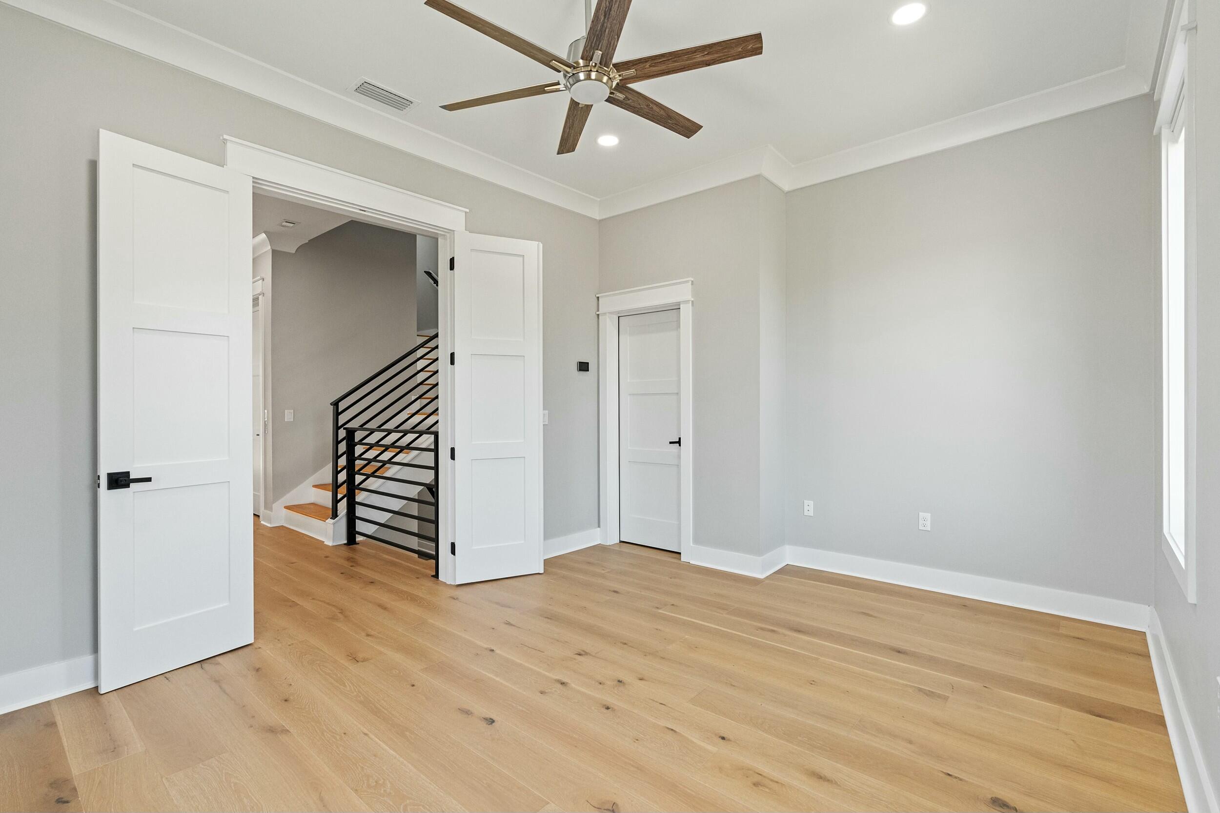 198 Emerald Ridge Santa Rosa Beach, FL 32459 - Photo 49 of 66 an empty room with wooden floor and ceiling fan