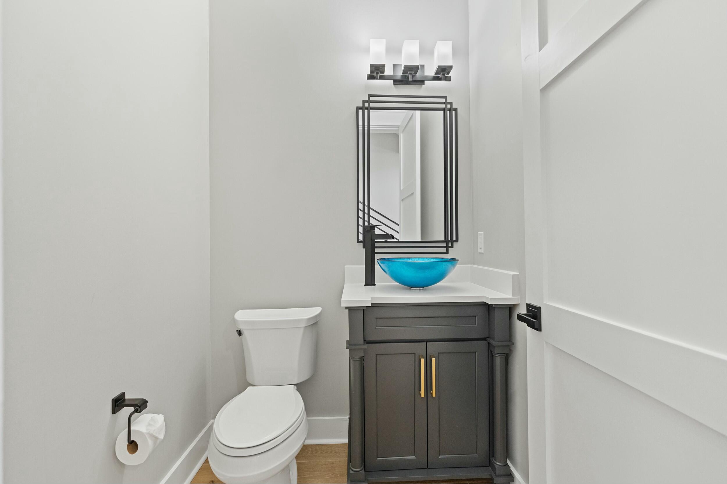 198 Emerald Ridge Santa Rosa Beach, FL 32459 - Photo 54 of 66 a bathroom with a toilet a sink and mirror