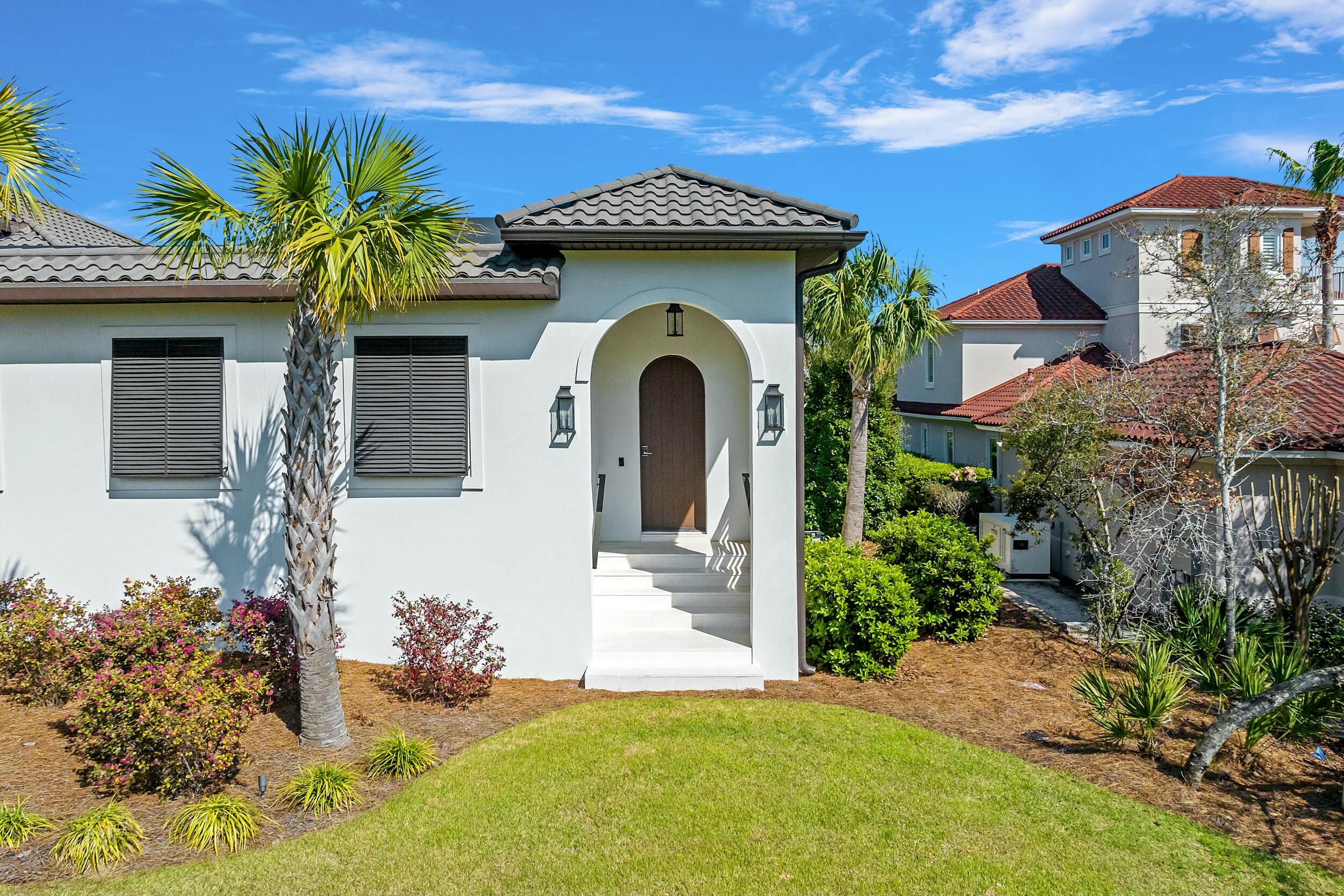 198 Emerald Ridge Santa Rosa Beach, FL 32459 - Photo 8 of 66 a front view of a house with a garden