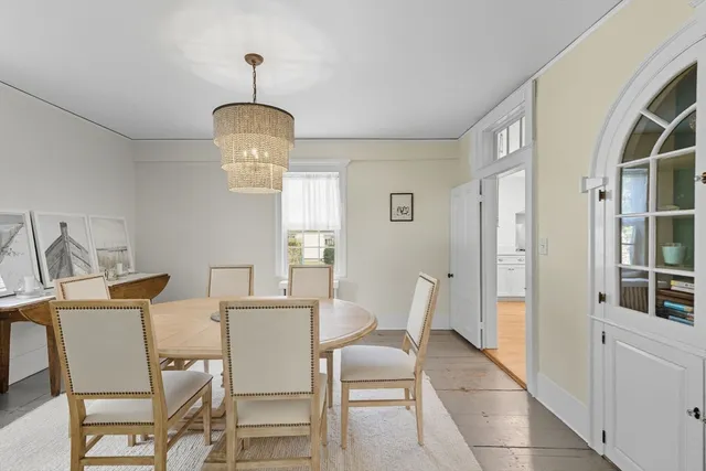 a view of a dining room with furniture and chandelier