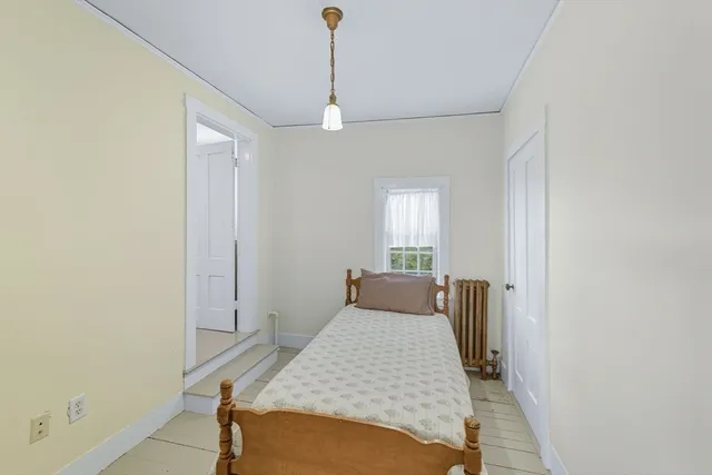 a bedroom with a bed and window