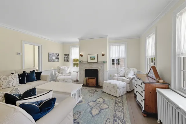 a living room with furniture a fireplace and a window