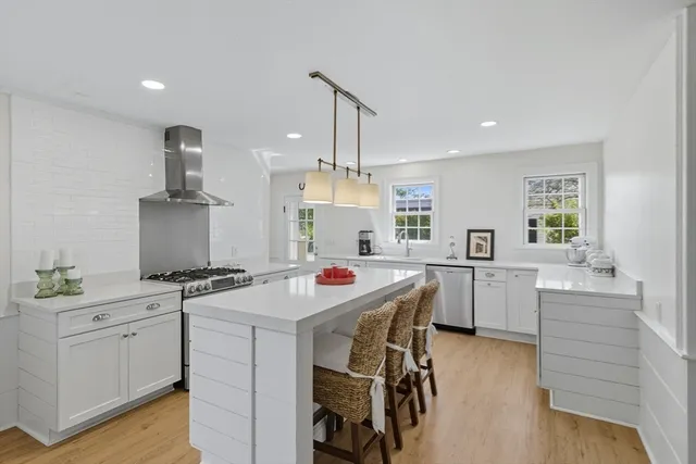 a kitchen that has a sink a stove and a table in it