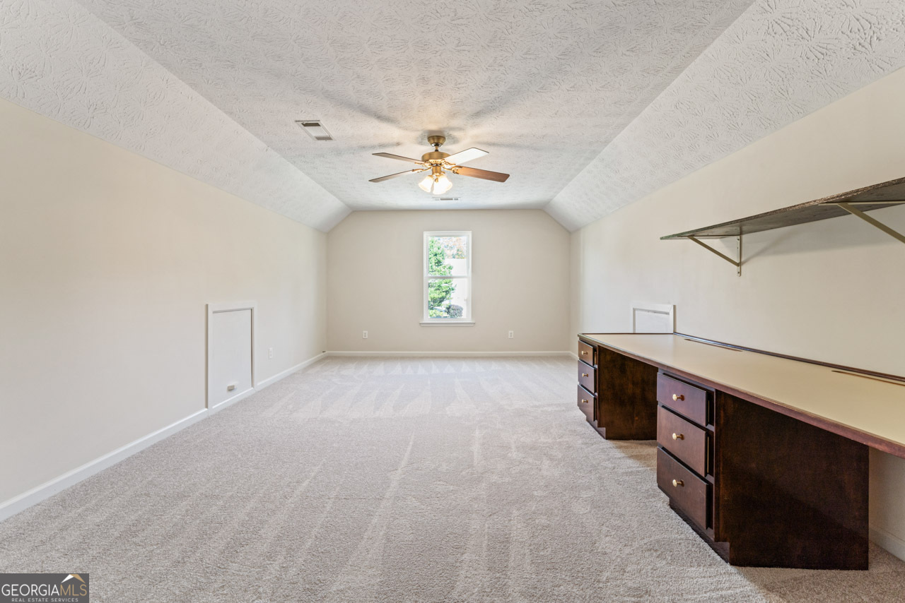 111 Cardell Farms Road Locust Grove, GA 30248 - Photo 23 of 37 a view of an empty room with a window and a kitchen