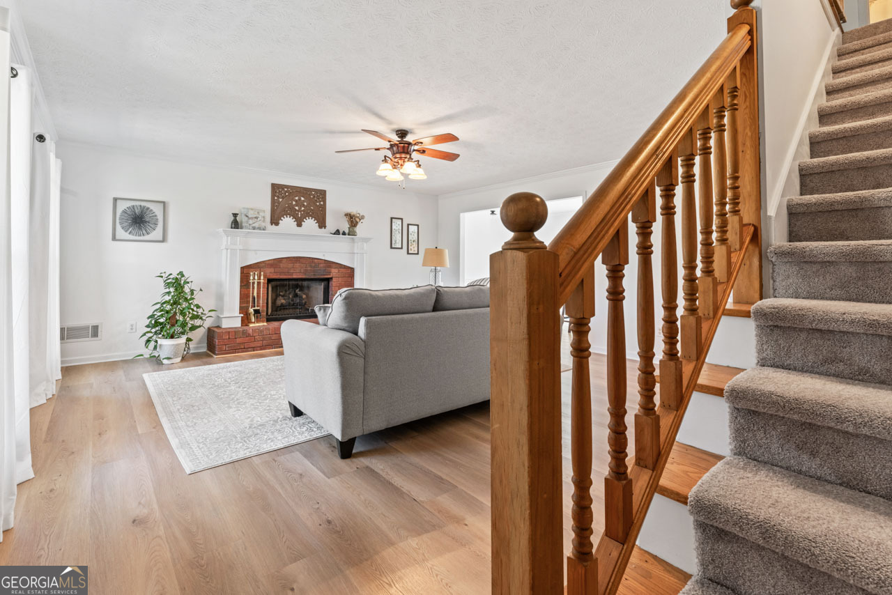 111 Cardell Farms Road Locust Grove, GA 30248 - Photo 4 of 37 a living room with furniture and a fireplace