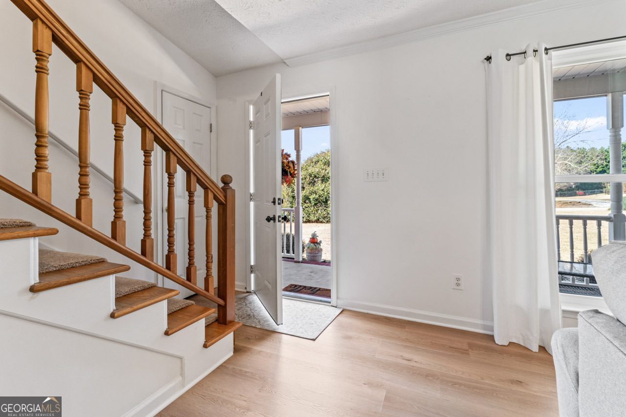 111 Cardell Farms Road Locust Grove, GA 30248 - Photo 5 of 37 a view of an entryway with wooden floor and door