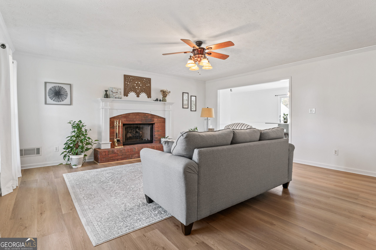 111 Cardell Farms Road Locust Grove, GA 30248 - Photo 6 of 37 a living room with furniture and a fireplace
