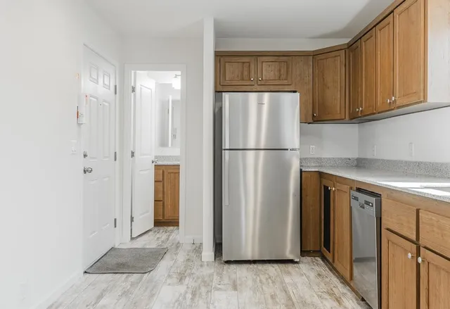 a view of kitchen with wooden floor and electronic appliances