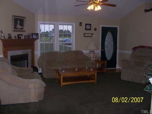 875 Bill Avery Road Coats, NC 27521 - Photo 2 of 8 a living room with furniture and a fireplace
