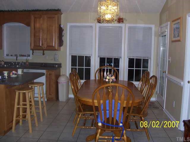 875 Bill Avery Road Coats, NC 27521 - Photo 5 of 8 a view of a dining room with furniture and chandelier