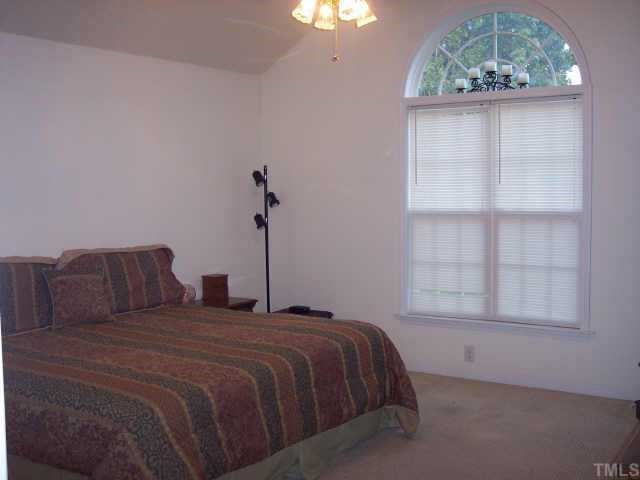 875 Bill Avery Road Coats, NC 27521 - Photo 6 of 8 a bedroom with a bed and a window