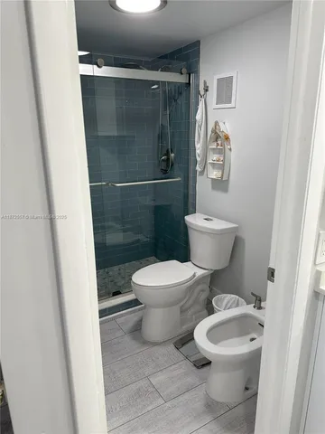 a bed room with a bed and a potted plant