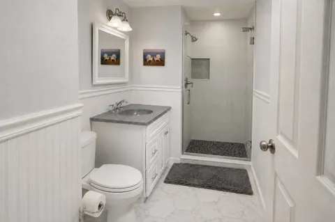 a bathroom with a sink toilet and shower
