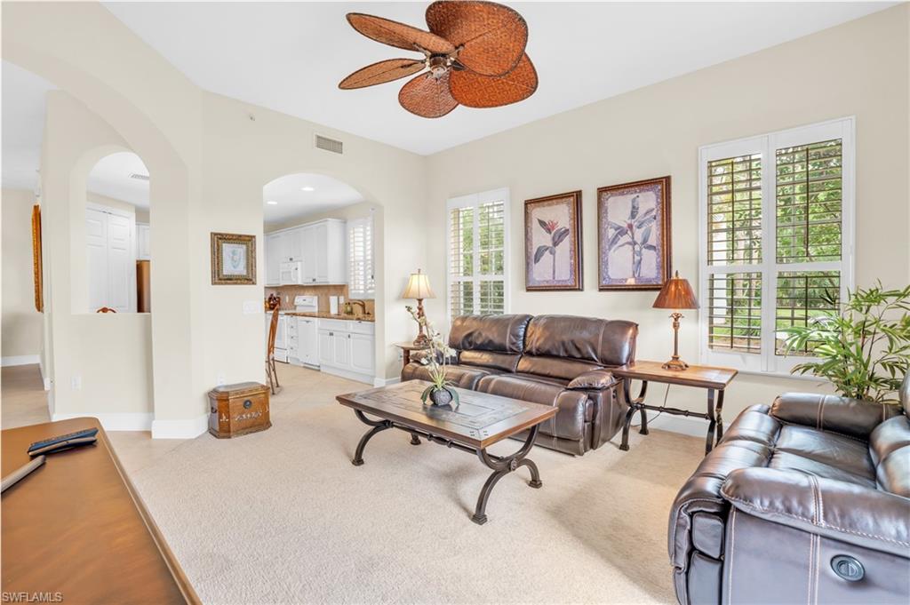 9006 Cascada Way, Unit 101 Naples, FL 34114 - Photo 13 of 25 a living room with furniture and a large window