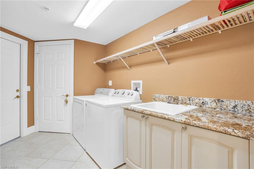 9006 Cascada Way, Unit 101 Naples, FL 34114 - Photo 24 of 25 a utility room with dryer and washer