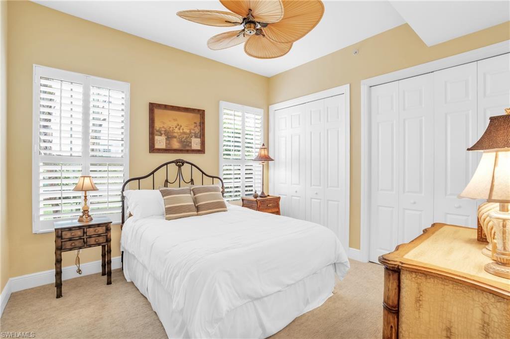 9006 Cascada Way, Unit 101 Naples, FL 34114 - Photo 25 of 25 a bedroom with a bed and a chandelier