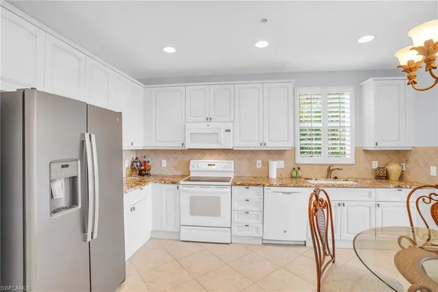 a kitchen with stainless steel appliances granite countertop a refrigerator sink and cabinets
