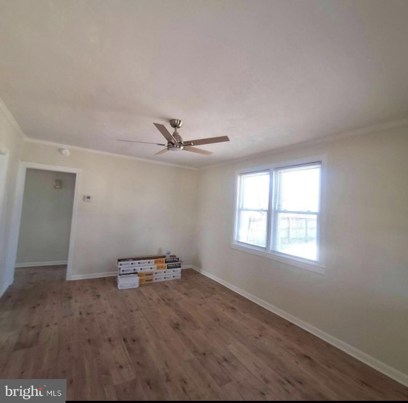 403 Trenton Court Wallingford, PA 19086 - Photo 3 of 11 a view of empty room with wooden floor and fan