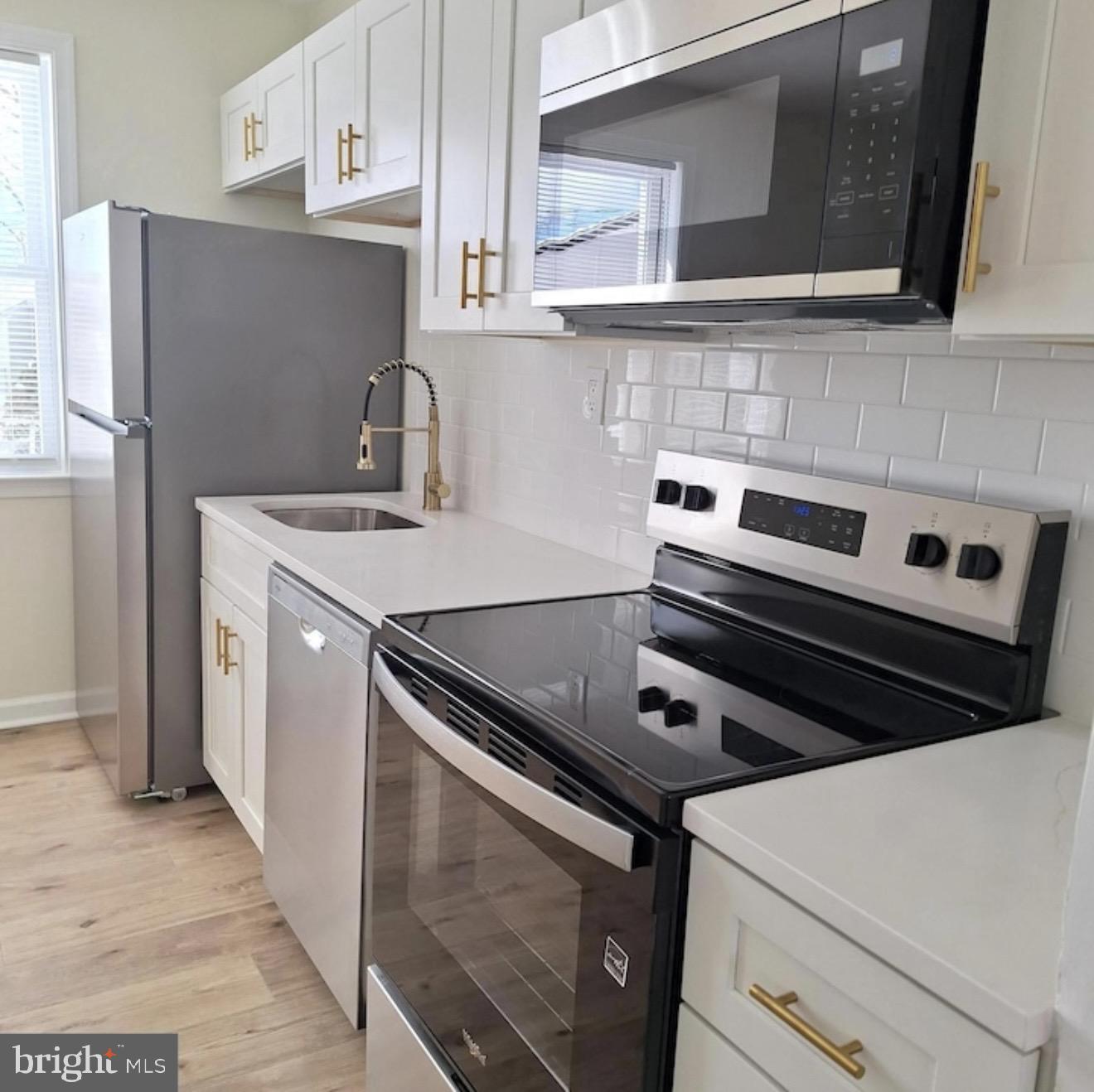 403 Trenton Court Wallingford, PA 19086 - Photo 6 of 11 a kitchen with a stove microwave and refrigerator