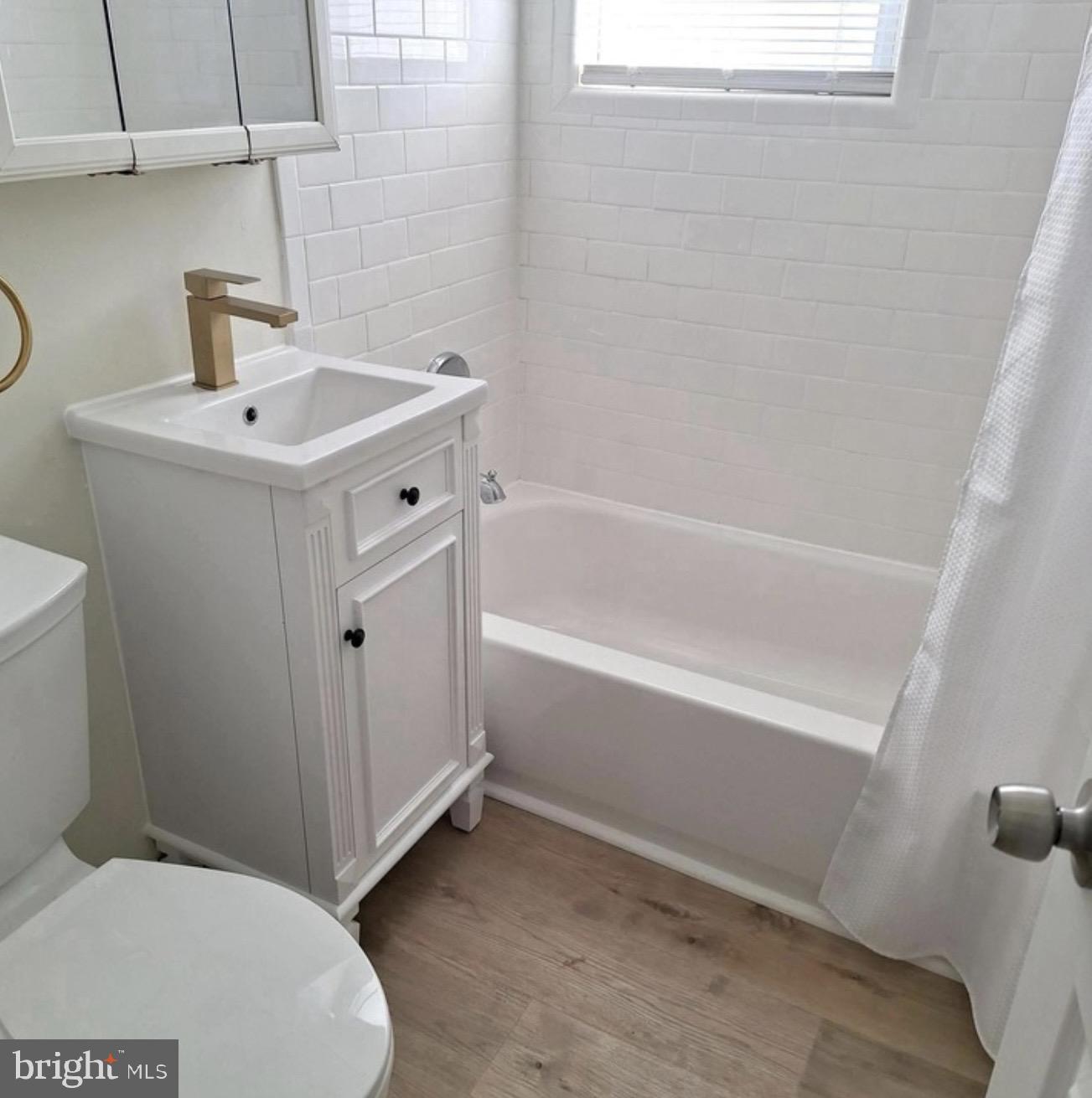 403 Trenton Court Wallingford, PA 19086 - Photo 10 of 11 a bathroom with a sink a toilet and shower