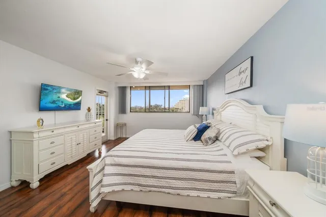 a bedroom with a bed and a flat screen tv