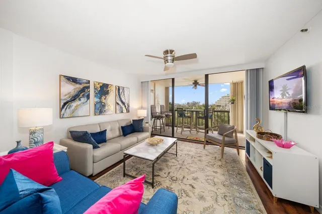 a living room with furniture and a floor to ceiling window