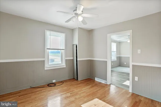 wooden floor in an empty room with a window
