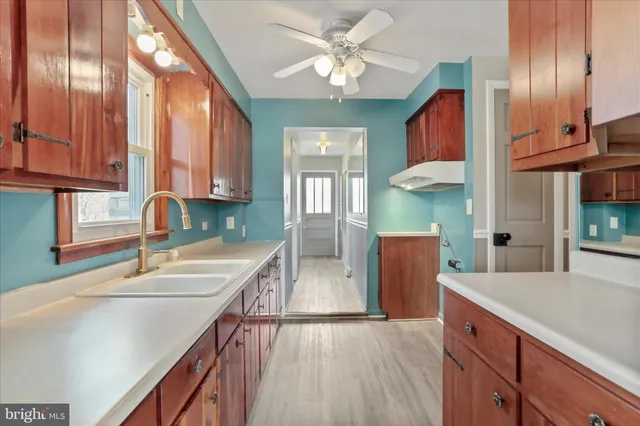 a kitchen with stainless steel appliances granite countertop a sink a counter space and cabinets