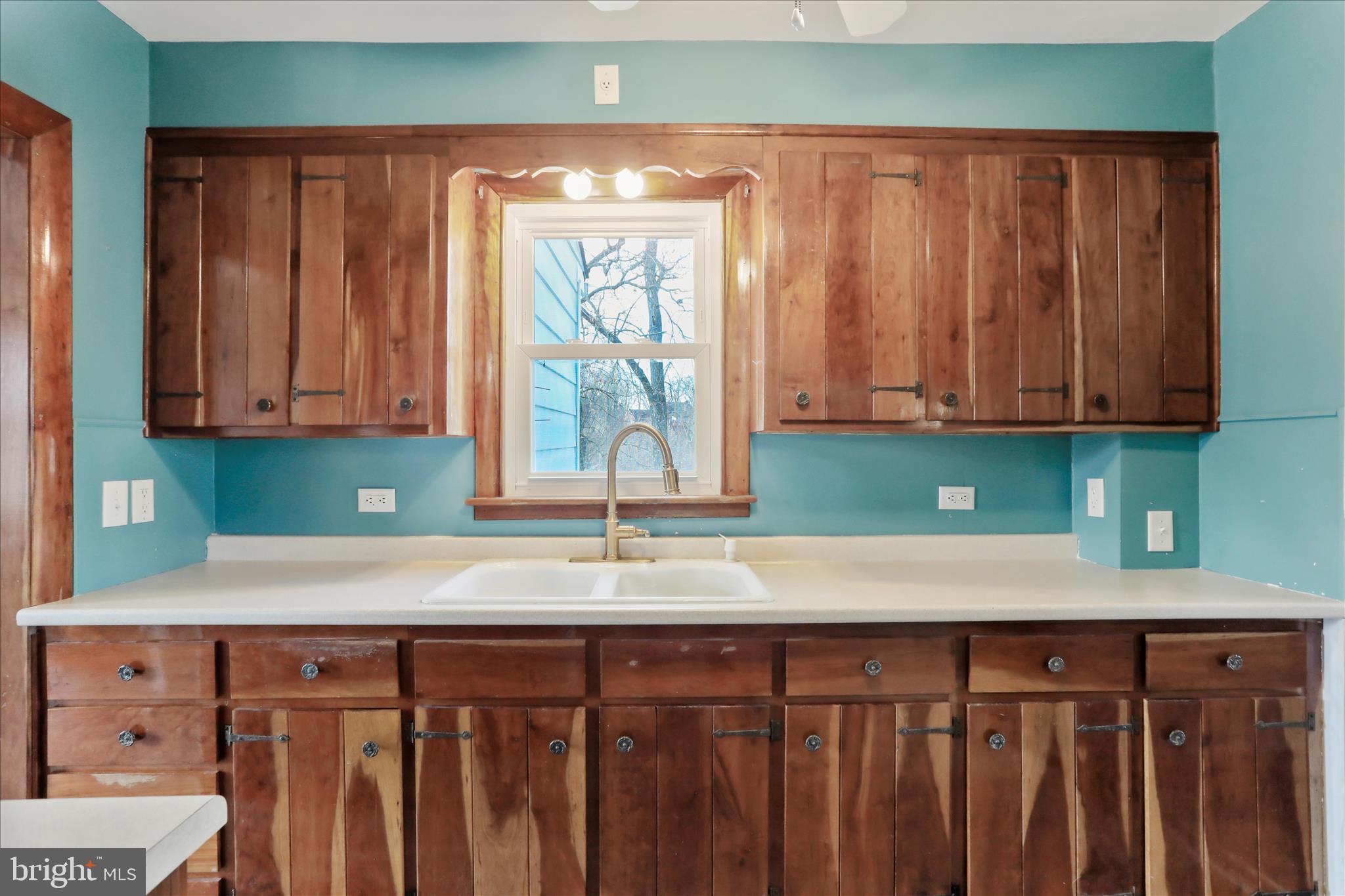 21938 Durberry Road Smithsburg, MD 21783 - Photo 16 of 55 a kitchen with a sink a cabinets and window
