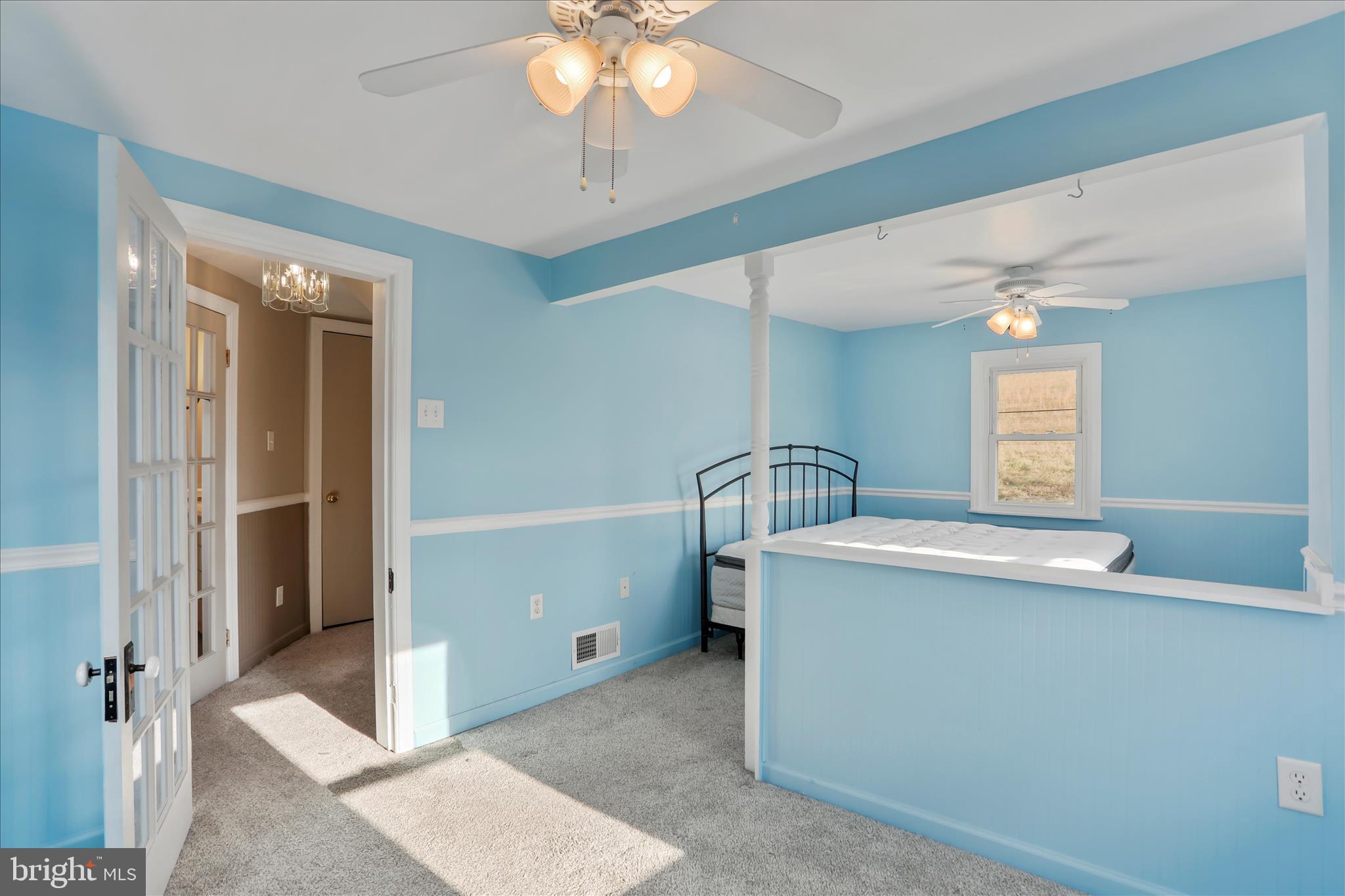 21938 Durberry Road Smithsburg, MD 21783 - Photo 23 of 55 a view of a hallway with a sink and chandelier