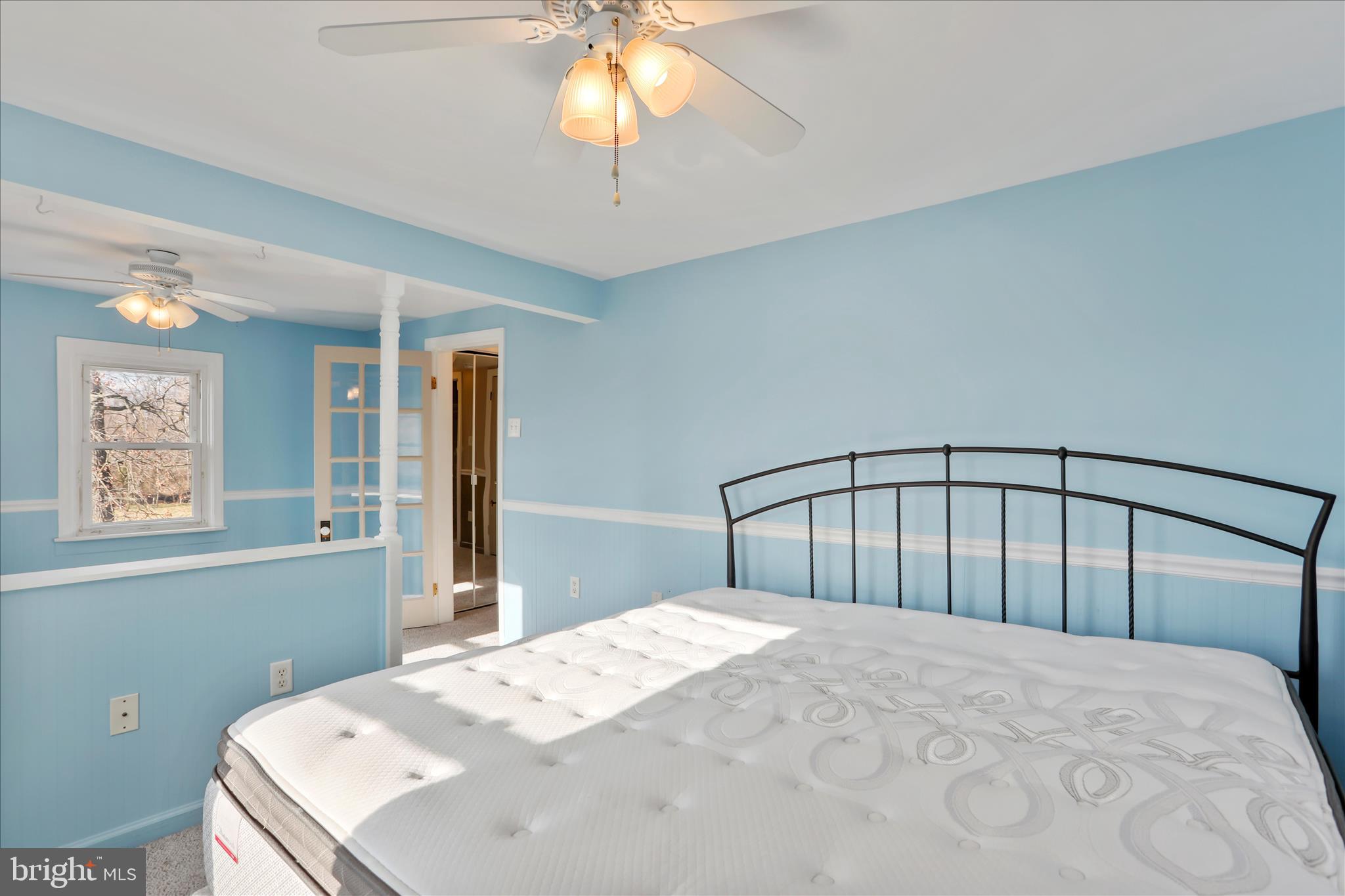 21938 Durberry Road Smithsburg, MD 21783 - Photo 25 of 55 a bedroom with a large bed and a chandelier