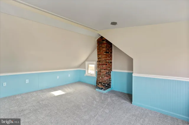 a view of a kitchen with furniture and an empty room