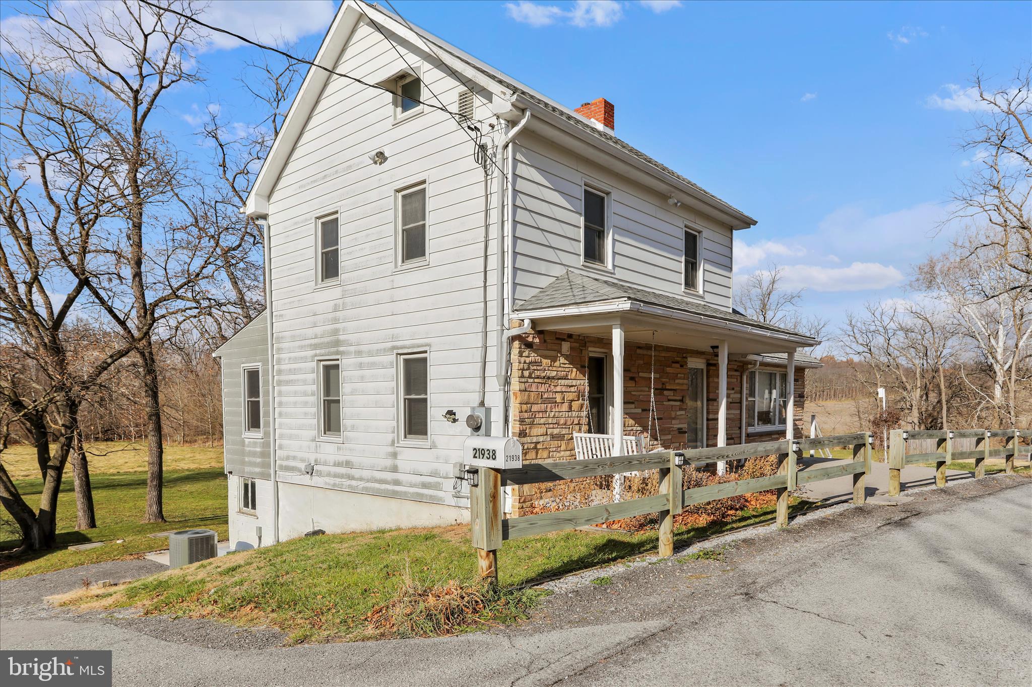 21938 Durberry Road Smithsburg, MD 21783 - Photo 4 of 55 a view of a white house with large windows next to a road