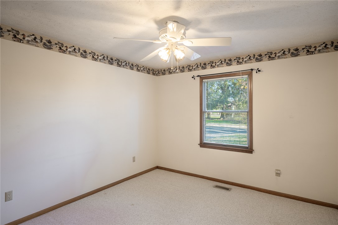 276 South Fairfield Road Bellbrook, OH 45305 - Photo 15 of 38 This cozy bedroom features carpet flooring and a window with blinds, creating a comfortable living space.