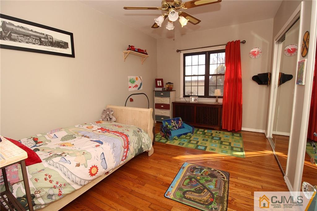 130 Ethel Road Edison, NJ 08817 - Photo 13 of 25 a bedroom with a bed and a chandelier